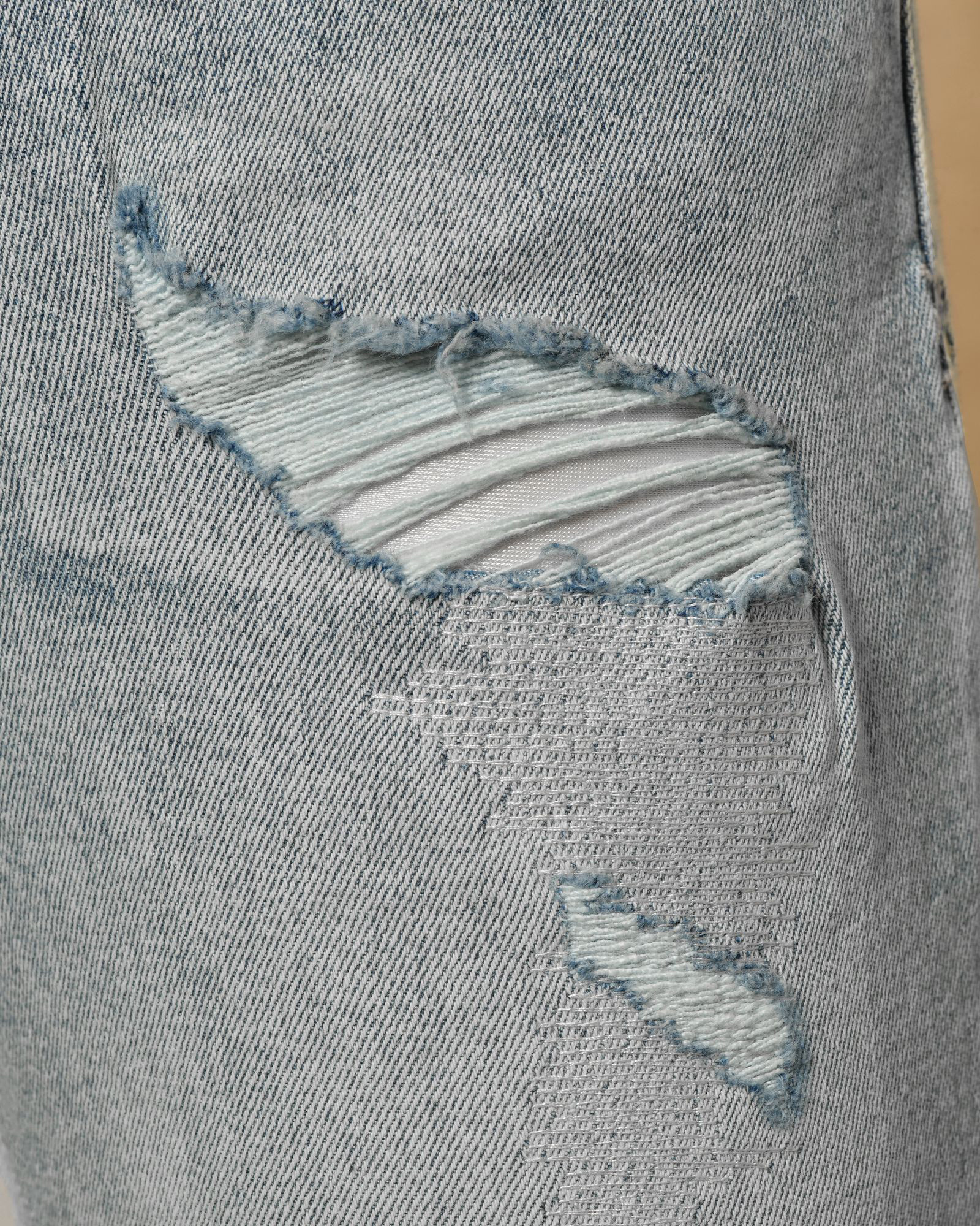 Jean délavé bleu à déchirures Ksubi