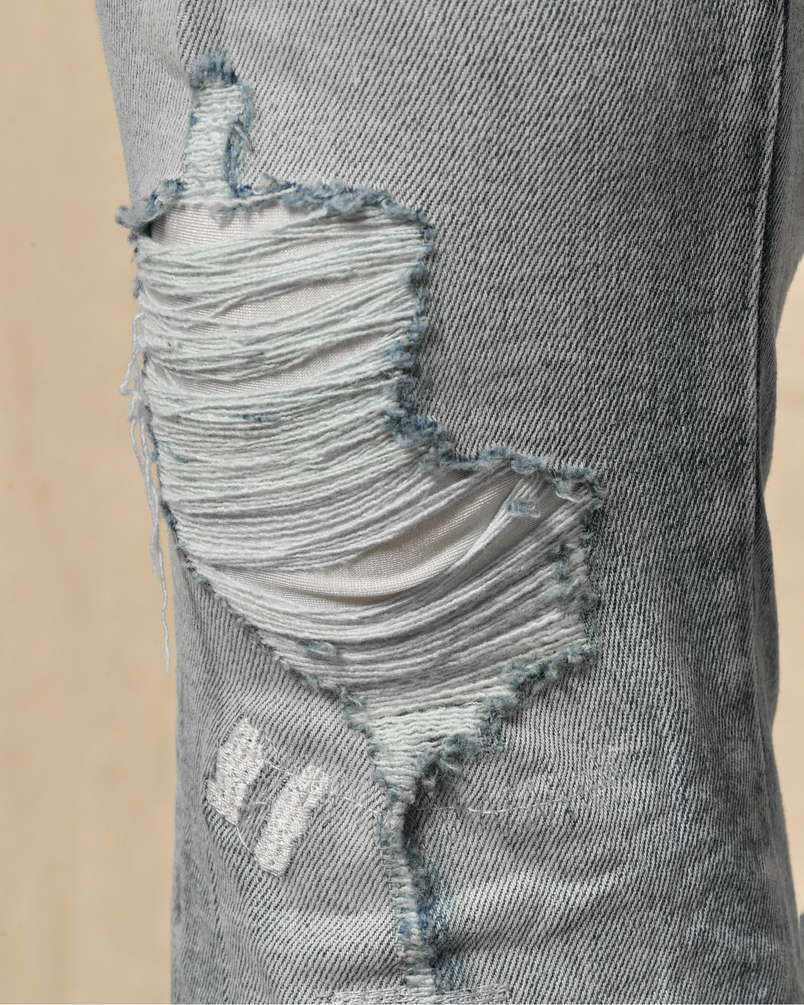 Jean délavé bleu à déchirures Ksubi